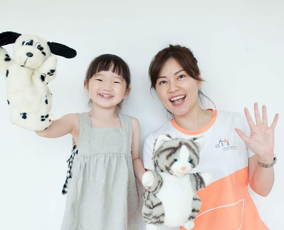 A-teacher-and-a-young-girl-joyfully-hold-up-their-stuffed-animals-showcasing-their-playful-bond-and-shared-happiness---Chengzhu-Mandarin-Centre-crop